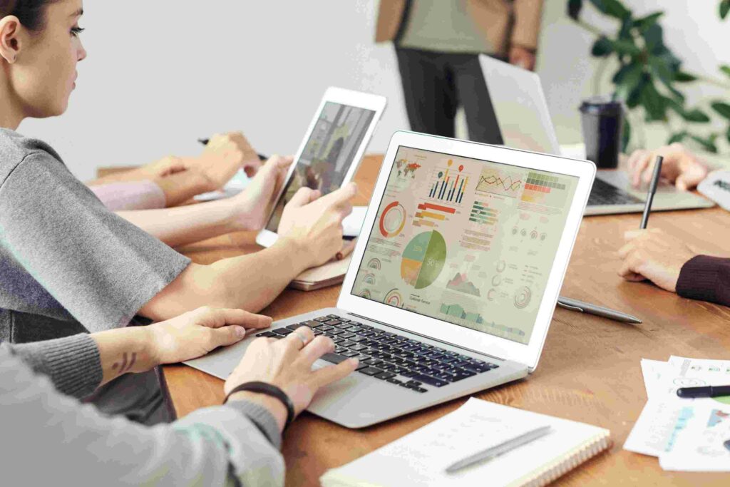 Sales team analyzing customer data on laptops